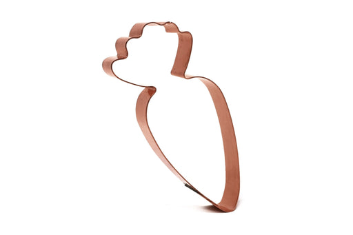 Copper cookie cutter shaped like a carrot on a white background