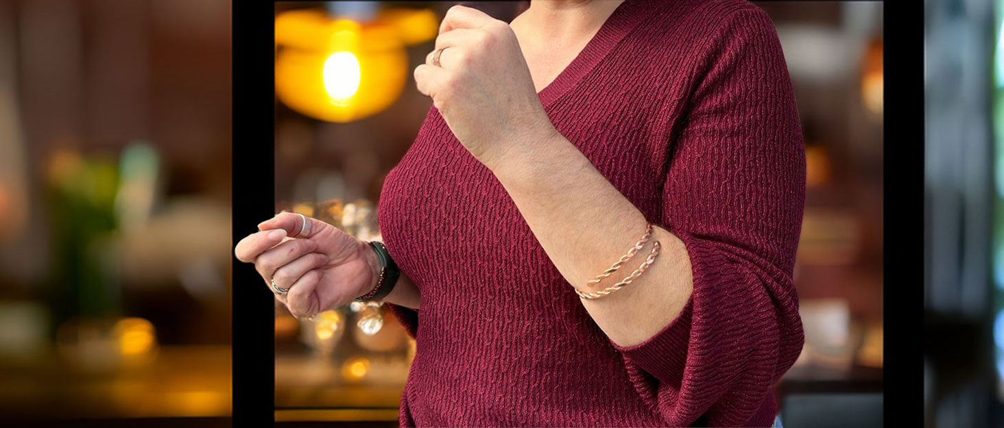 Handmade copper bangles on a woman’s wrist, showcasing The Fussy Pup’s artisan jewelry collection of bracelets, cuffs, and unique accessories.