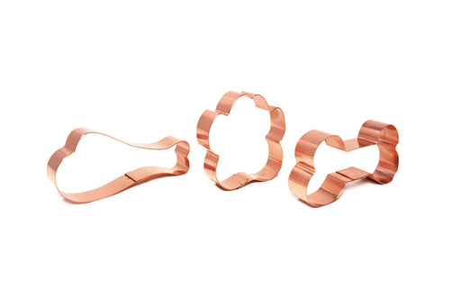 Three-piece copper cookie cutter set featuring a paw, chicken leg, and bone designs on a white background.