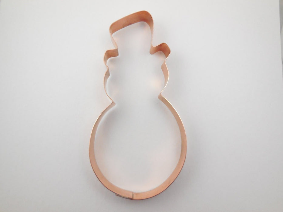 Snowman-shaped cookie cutter on a white background