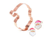 Copper Santa Claus cookie cutter with two decorated cookies on a white background