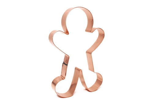 A copper cookie cutter in the shape of a gingerbread man.